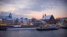 Sunset over Maastricht's docks, with a boat on the water.