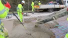 Men in PPE carry out repairs to the concrete road section of the M54