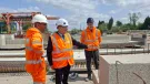 Three men in PPE, including Councillor Tony Eaton, chairman of Bassetlaw District Council, examine precast concrete elements in ABM Precast Solutions' yard during the company's 20th Anniversay celebrations.