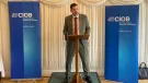 Mike Reader MP, the new chair of the All-Party Parliamentary Group for Excellence in the Built Environment, stands behind a podium, flanked by CIOB banners, speaking at the launch of the CIOB's Construction Client Guide: Leading Projects in the Built Environment, in Parliament last week.