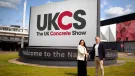 Richard Bradbury (right), Managing Director of The QMJ Group with Helaena Ackers, Exhibition Sales Account Manager, The NEC shake hands outside the NEC in front of a huge UK Concrete Show sign, following the signing of a two-year deal that sees the flagship trade show to stay at Birmingham’s NEC through 2027, with free parking and expanded plans for 2026 edition