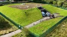 An aerial photo shows men in PPE and two vans at Stanley Hollowhouse following the installation of the cement-free, basalt-reinforced base for Scottish Water’s first verified Net Zero site.