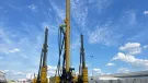 Three yellow piling rigs on a hard stand at RBL.