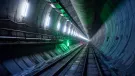 A diimly lit, concrete lined tunnel, Part of the newly completed westbound tunnel on the Italian side of the Brenner Base Tunnel. Over 400,000 precast segments will be used in total. (Image: Webuild)