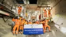 A large group of people in orange PPE, part of HS2 tunnelling team celebrates, TBM Emily completing 5.5km journey. Image: HS2.