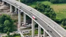 Workers monitor the precise hydraulic shift of the 40,000-tonne Rinsdorf viaduct, moved laterally into position in a German engineering first.