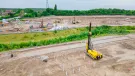 A yellow foundation rig prepares to start work at a large housing project in St Helens.