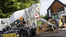 Two men unload concrete from one of Micromix’s agile trucks, which can deliver concrete loads from 0.5 to 4 m³, now with added convenience via online ordering.