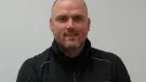 A bald man in a black fleece branded with the Bay-Lynx logo.
