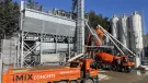 An orange tipper truck and orange cement mixer wait by the new iMIX plant in Essex is MCT Italy’s first UK ready-mix installation, built for high-volume output and flexibility.
