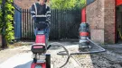 A man with beard using one of Trelawny’s new VoltMax range, which includes a grinder, scarifier and stripper – all powered by 82V lithium-ion batteries, prepares a surface for construction work