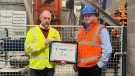 Chris Jones (right) of Mona Precast with David Wyke (left) of KVM, marking 25 years of block production at the Anglesey site.
