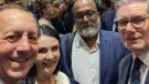 Four people look into the camera to take a selfie
