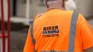 A construction worker in Biker Group branded orange PPE and hard hat