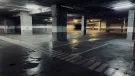 A dimly lit underground concrete carpark